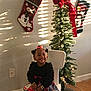 architecture, baby, building, christmas, christmasdecorations, clothing, face, festival, gift, head, hosiery, indoors, lighting, person, photography, plant, portrait, pottedplant, sock, tree