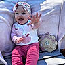 Josie is registered to the contest to win money with this photo: baby, blanket, bow, chair, child, decorative_sign, four_months, grass, happy, headband, infant, long_sleeves, milestone, outdoor, pants, pink_clothing, portrait, sitting, smiling, sunlight