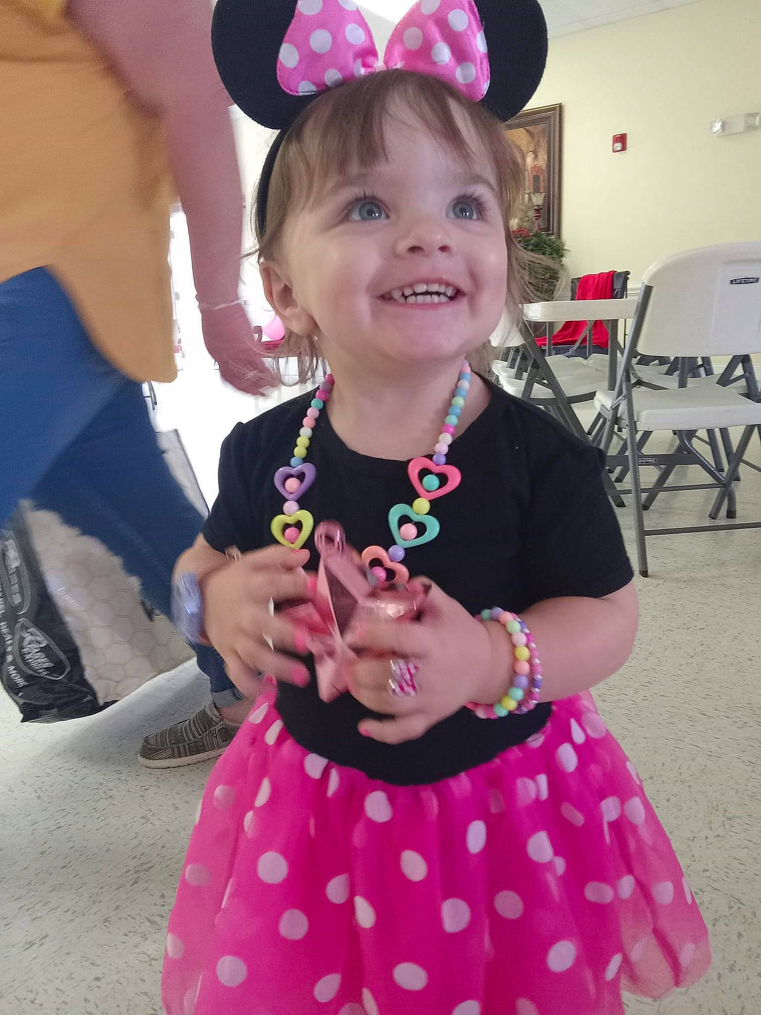 Persephone is registered to the contest to win money with this photo: baby_toddler_clothing, chair, child, costume, day_dress, event, facial_expression, fun, hairstyle, happy, hat, jewellery, joy, magenta, necklace, person, pink, purple, sleeve, smile