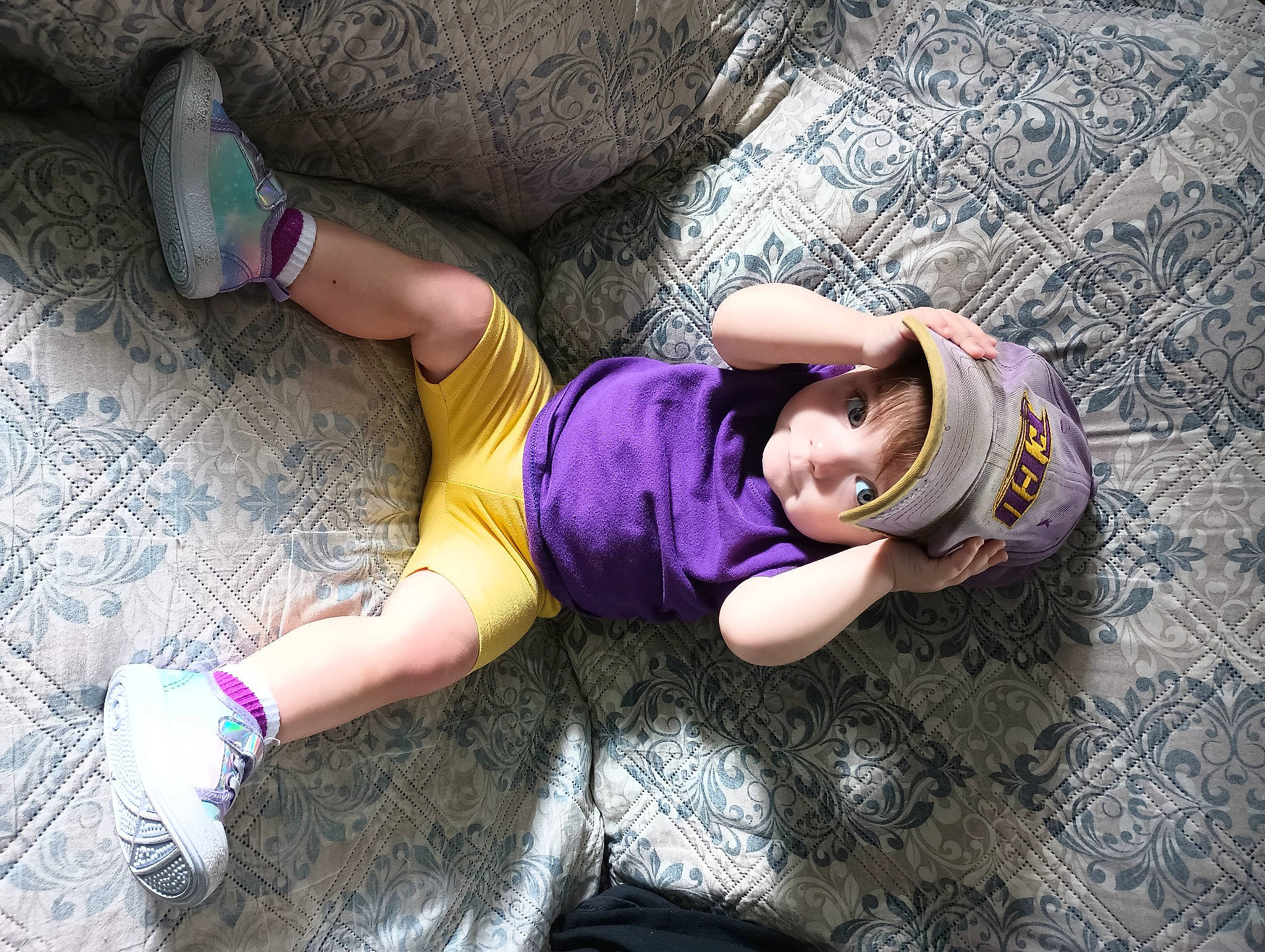 Persephone is registered to the contest to win money with this photo: cap, child, cool, flooring, grass, happy, hat, human_leg, knee, leg, leisure, person, pink, plant, purple, shoe, sneakers, thigh, toddler, tree