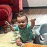 Jimmy is registered to the contest to win money with this photo: baby, child, smiling, sitting, rug, toy, foam_roller, baby_seat, floor, wood_floor, furniture, couch, armchair, clothing, shorts, tshirt, indoor, happy, person, home