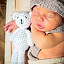 baby, sleeping, teddy_bear, crochet, hat, infant, cute, peaceful, soft, cozy, child, portrait, resting, hand, clothing, fabric, closeup, indoors, newborn, relaxed