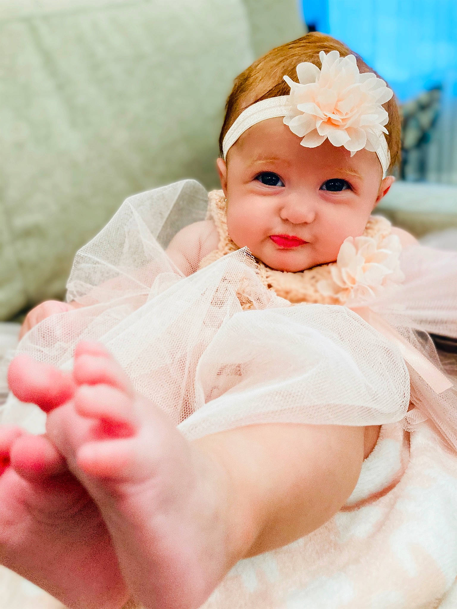 Norma is registered to the contest to win money with this photo: arm, baby, baby_toddler_clothing, comfort, dress, eyelash, face, finger, hand, happy, headgear, headpiece, headwear, human_body, leg, lip, person, pink, skin, thumb