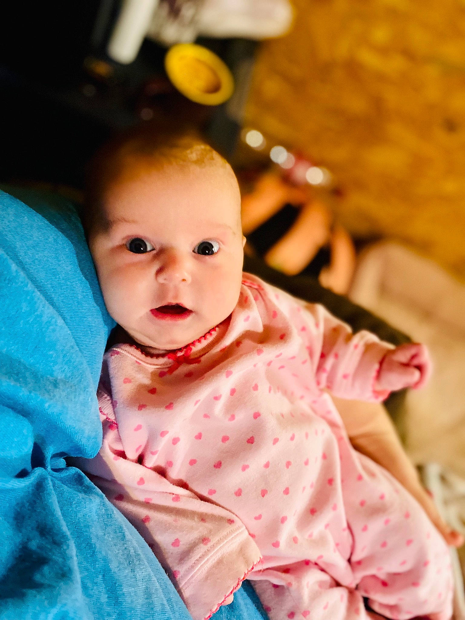 Lea is registered to the contest to win money with this photo: baby, baby_products, baby_toddler_clothing, cheek, child, dress, fun, happy, iris, leisure, linens, lip, orange, peach, person, pink, portrait_photography, sitting, skin, sleeve