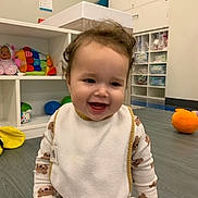 Rayna joined the competition — help win amazing prizes! toddler, child, smiling, baby, pajamas, bib, indoor, playroom, floor, toy, colorful, cabinet, sitting, happy, face, clothing, babytoy, furniture, childcare, room