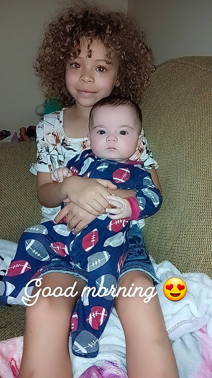 Raelynn is registered to the contest to win money with this photo: baby, baby_toddler_clothing, cheek, child, comfort, eye, face, fun, hairstyle, happy, head, iris, jheri_curl, joy, lap, organ, person, ringlet, skin, smile