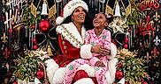 Kiylee is registered to the contest to win money with this photo: child, adult, santa, christmas, holiday, festive, smiling, laughing, portrait, throne, costume, red_suit, pink_pajamas, christmas_tree, ornaments, poinsettias, bows, bells, black_background, royal