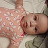 Abigail Joy joined the competition — help win amazing prizes! baby, infant, child, onesie, pink_clothing, bows, bed, blanket, soft_texture, face, portrait, lying_down, curious, pout, wide_eyes, cute, indoor, sleepwear, closeup, person