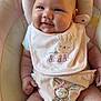 baby, infant, smiling, pink, bib, bunny, plush, baby_seat, cute, happy, child, clothing, diaper_cover, chubby_cheeks, skin, head, face, seated, indoors, soft_lighting