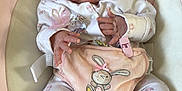 Ocean is registered to the contest to win money with this photo: baby, sleeping, infant, pajamas, bunny, soft_toys, child, cute, pink, pastel_colors, baby_seat, comfort, peaceful, indoor, home, newborn, small_hands, footed_pajamas, resting, adorable