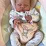 baby, sleeping, infant, pajamas, bunny, soft_toys, child, cute, pink, pastel_colors, baby_seat, comfort, peaceful, indoor, home, newborn, small_hands, footed_pajamas, resting, adorable
