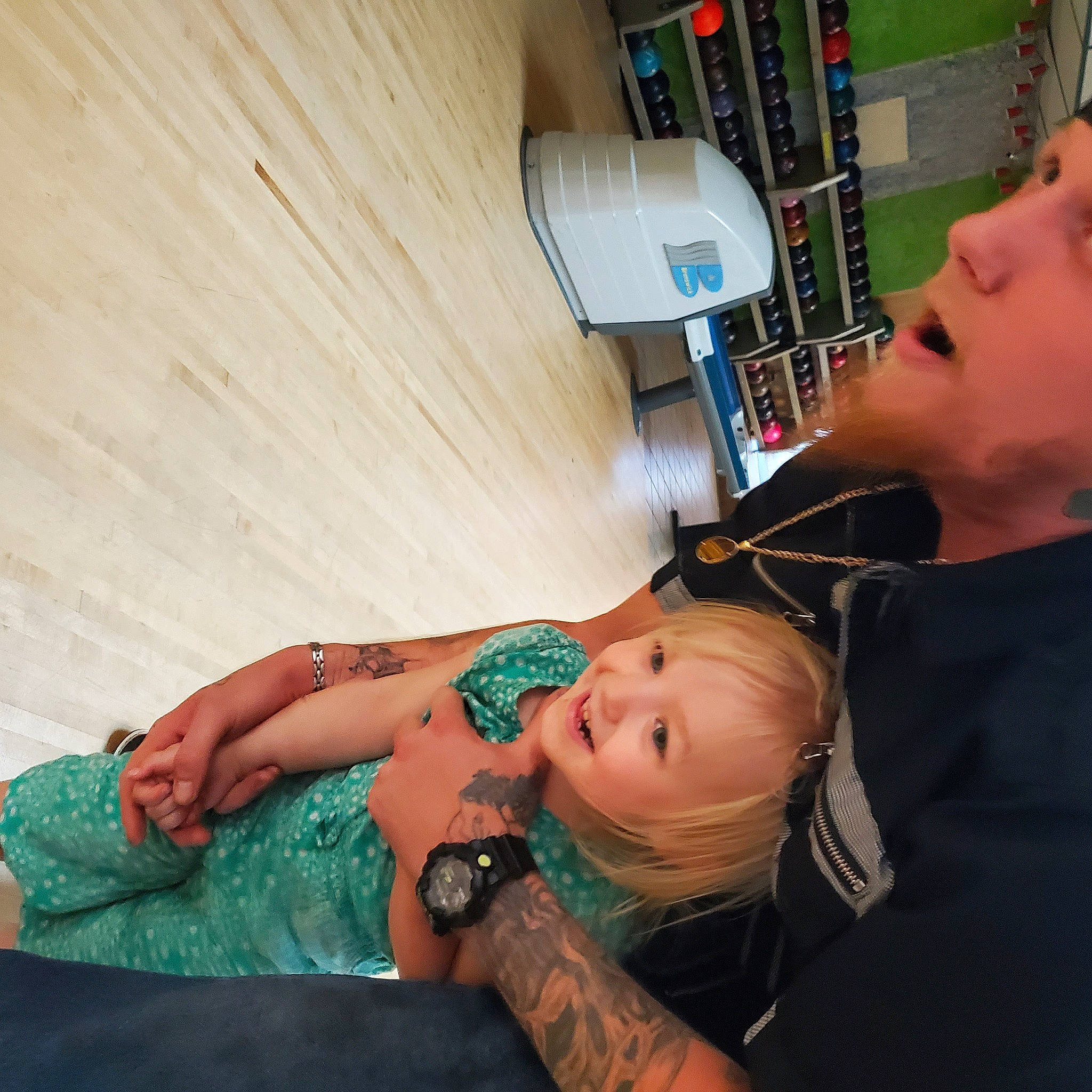 Hazel is registered to the contest to win money with this photo: abdomen, arm, audio_equipment, bookcase, chest, child, elbow, eyelash, human_leg, jewellery, joint, joy, person, service, shelf, shoulder, skin, tattoo, thigh, toddler