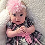 baby, child, infant, headband, flower, pink, dress, plaid, bow, hands, clasped, wide_eyes, blanket, soft, cute, portrait, indoors, person, young, cozy