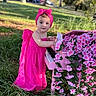 toddler, child, pink_dress, headband, piano, flowers, outdoor, grass, greenery, nature, daylight, portrait, cute, playing, music, toy_piano, flower_decoration, young_child, colorful, park