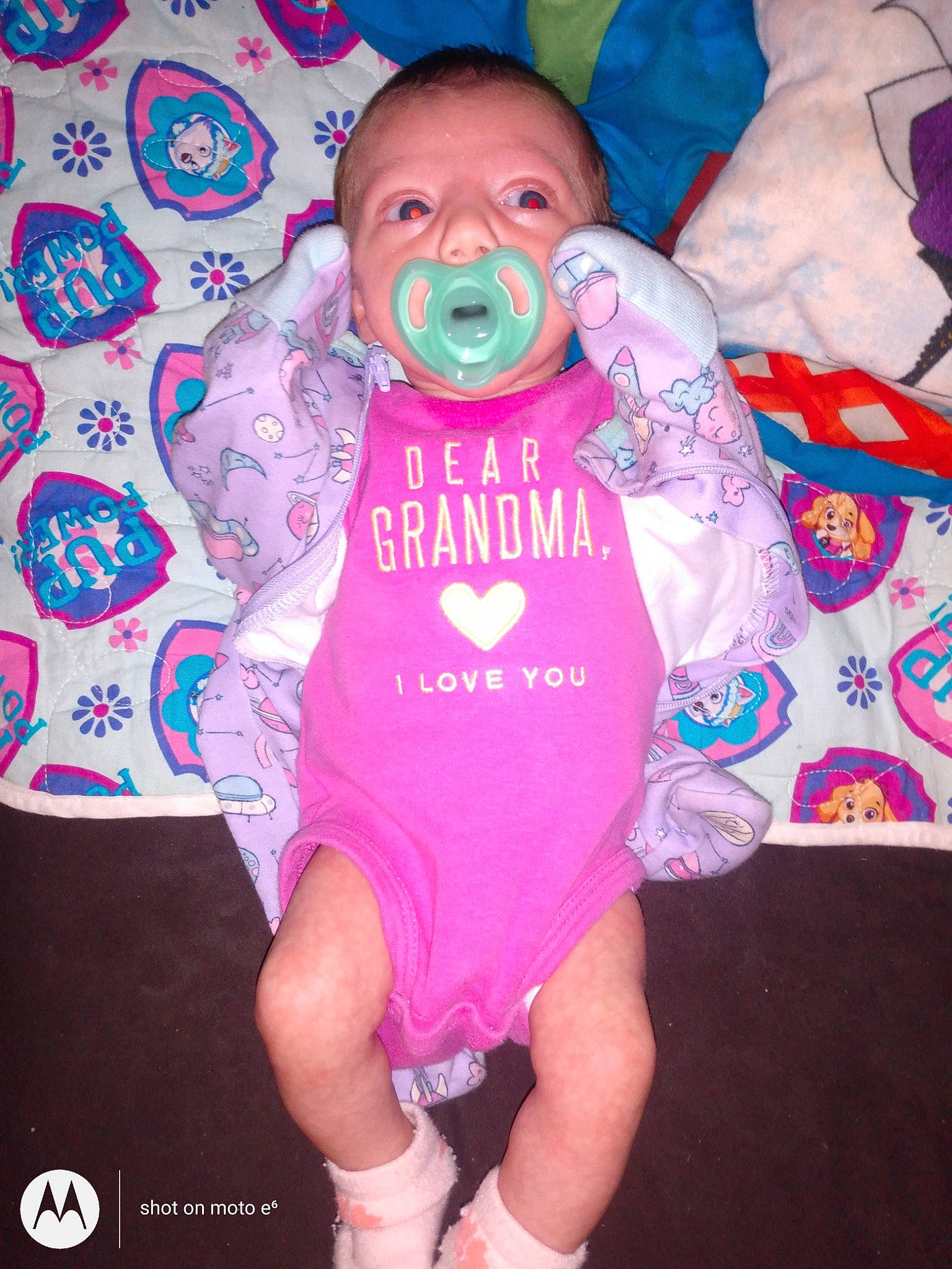 Alexis Rose is registered to the contest to win money with this photo: baby, baby_products, baby_toddler_clothing, child, event, finger, fun, happy, human_body, linens, magenta, pattern, person, personal_protective_equipment, pink, purple, sleeve, t_shirt, thigh, toddler