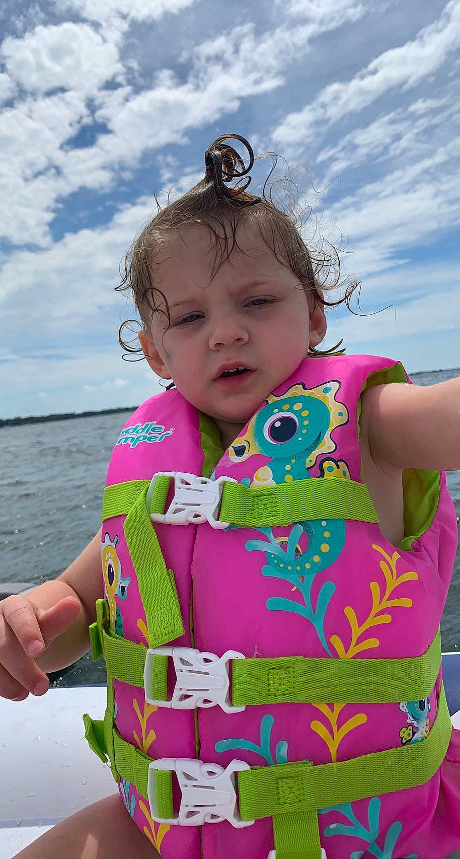 Lucille is registered to the contest to win money with this photo: baby, baby_toddler_clothing, blue, cloud, cool, facial_expression, fun, happy, leisure, magenta, neck, person, pink, recreation, skin, sky, sleeve, summer, toddler, travel