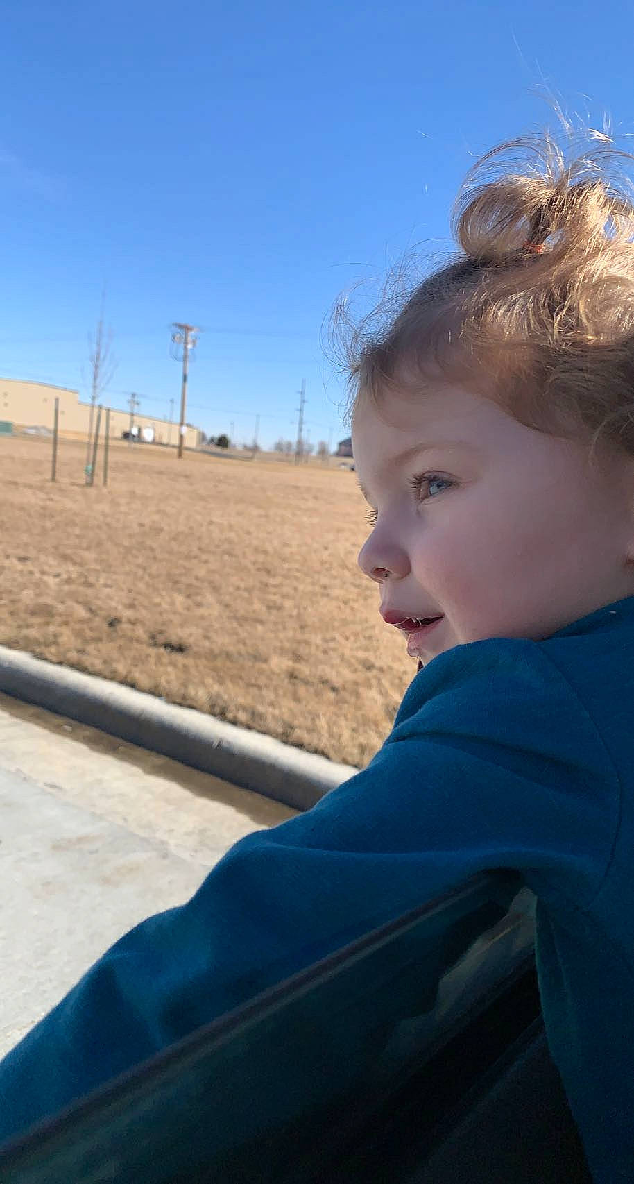 Lucille is registered to the contest to win money with this photo: child, electric_blue, eyebrow, fun, grass, happy, horizon, landscape, leisure, person, road, sand, sitting, skin, sky, soil, toddler, travel, tree, vacation