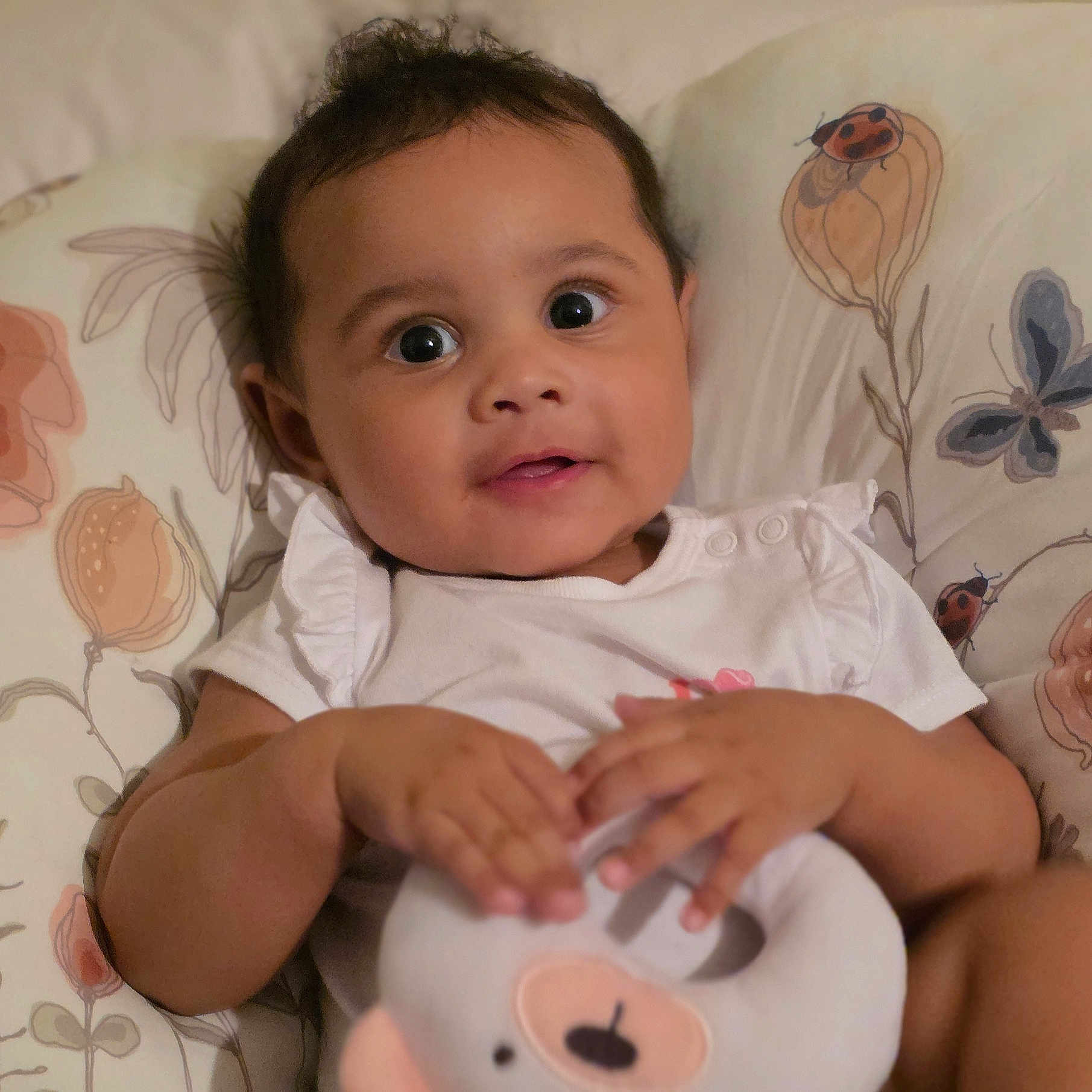 Nayelie joined the competition — help win amazing prizes! baby, bear, butterfly, child, cushion, cute, eyes, face, hair, hand, indoor, infant, ladybug, mouth, portrait, skin, smiling, soft_toy, toy, white_clothing