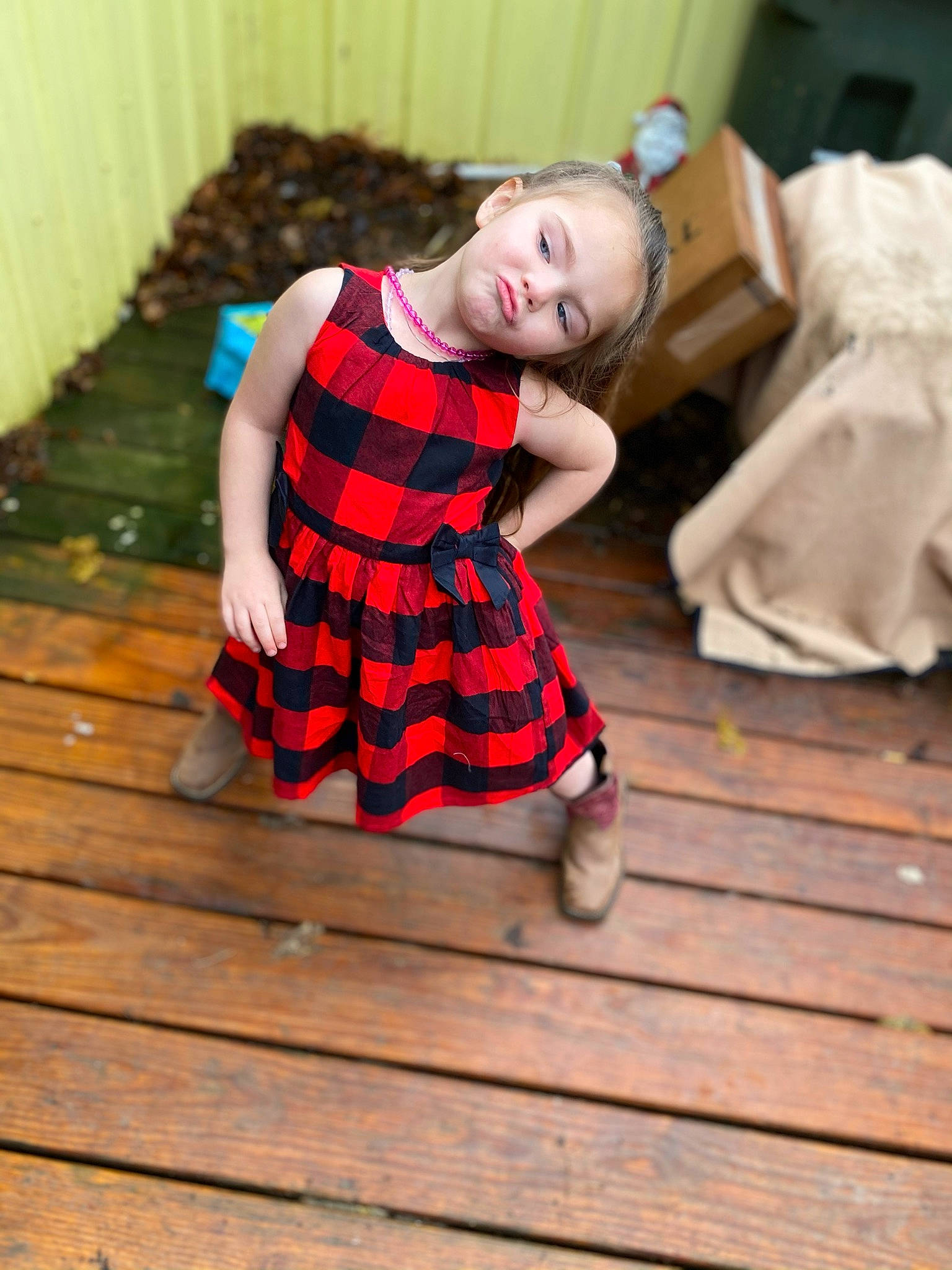 Aubrianna joined the competition — help win amazing prizes! baby_toddler_clothing, dress, eye, face, floor, flooring, happy, hardwood, head, human_leg, knee, leg, pattern, person, plaid, sock, tartan, thigh, toddler, wood