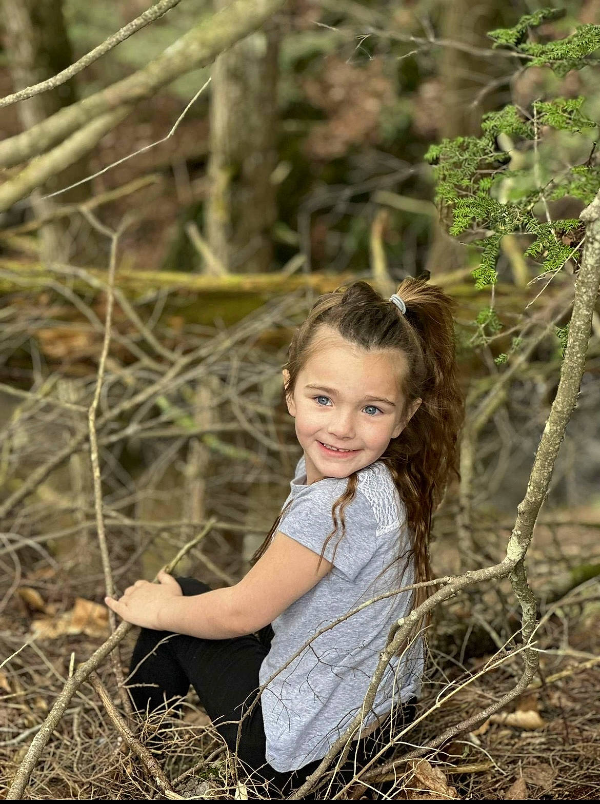 Aubrianna joined the competition — help win amazing prizes! blond, branch, brown_hair, eye, fawn, flash_photography, forest, fun, grass, happy, joy, long_hair, natural_landscape, people_in_nature, person, plant, smile, toddler, trunk, twig