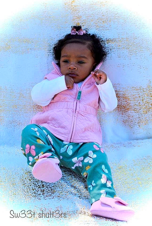 Kalaigha is registered to the contest to win money with this photo: baby, baby_toddler_clothing, cheek, child, happy, person, pink, play, sitting, skin, smile, toddler