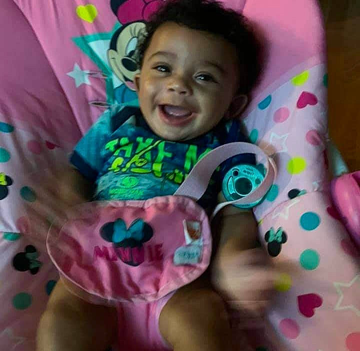 Nahla is registered to the contest to win money with this photo: baby, baby_toddler_clothing, child, eye, face, finger, happy, head, joy, linens, magenta, mammal, neck, person, pink, shirt, skin, sleeve, smile, t_shirt