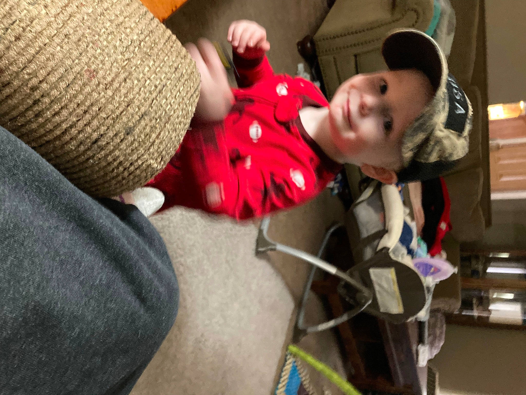 Dallas is registered to the contest to win money with this photo: audio_equipment, baby, baby_products, baseball_cap, cap, car_seat, child, comfort, fun, headgear, headwear, joy, knit_cap, lap, person, personal_protective_equipment, room, sitting, smile, toddler