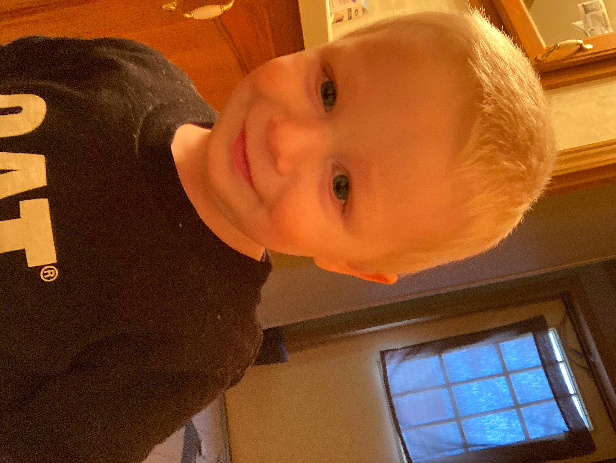 Dallas is registered to the contest to win money with this photo: baby, baby_toddler_clothing, cheek, child, chin, eyebrow, facial_expression, forehead, human_body, jaw, joy, mouth, neck, nose, person, room, sleeve, smile, t_shirt, toddler