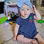 Sunshine is registered to the contest to win money with this photo: baby, child, blue_bow, striped_dress, carpet, toys, indoor, sitting, curious, playtime, headband, cute, floor, plastic_toys, colorful, person, young_child, room, furniture, baby_toys