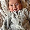 Amyrah is registered to the contest to win money with this photo: baby, bed, blanket, clothing, coat, face, furniture, happy, head, hoodie, jacket, knitwear, newborn, person, photography, portrait, quilt, smile, sweater, towel