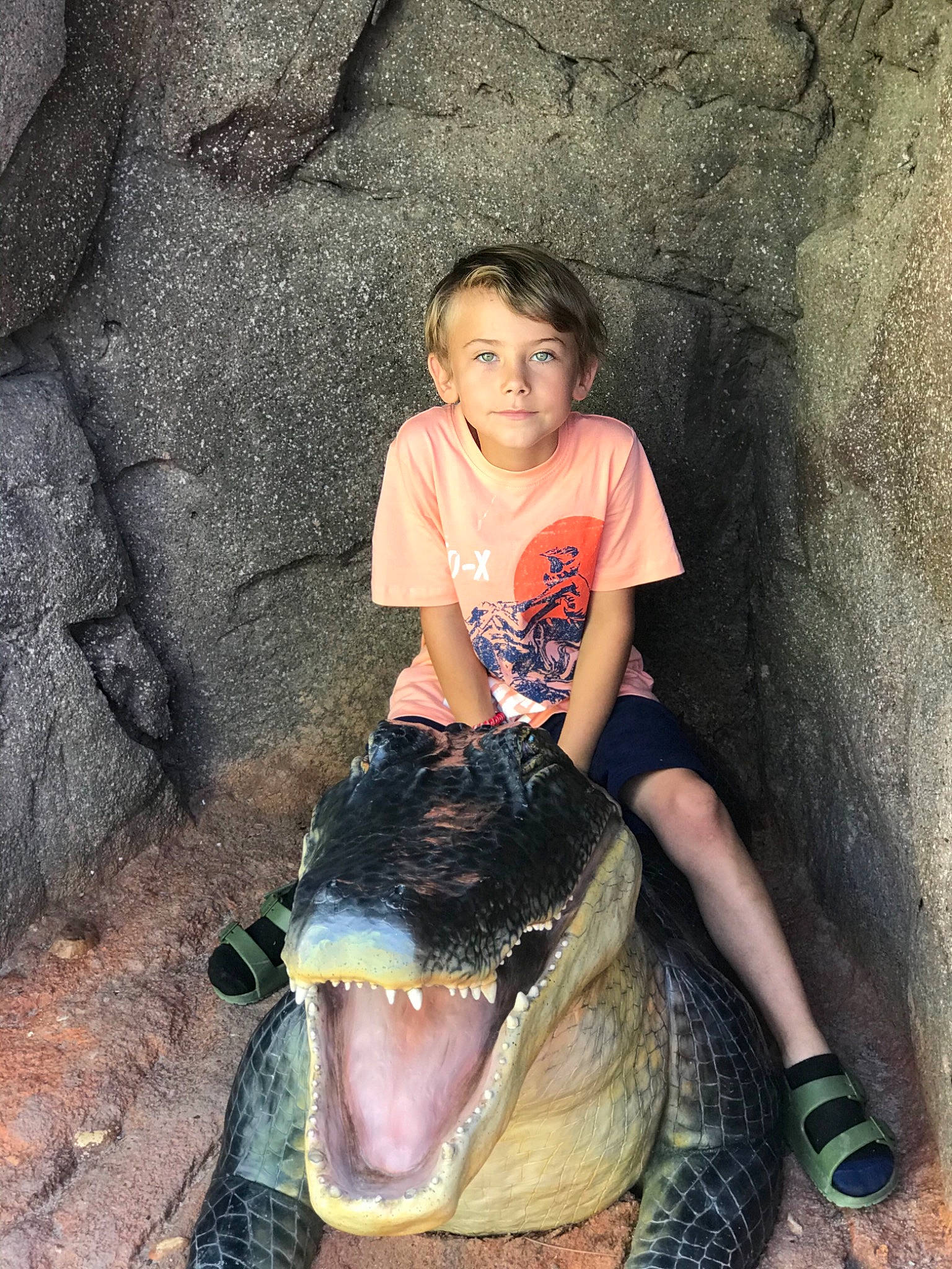 Hunter is registered to the contest to win money with this photo: child, eye, facial_expression, fang, fish, flash_photography, fun, fur, happy, jaw, leisure, mouth, person, recreation, rock, shorts, sitting, smile, soil, t_shirt