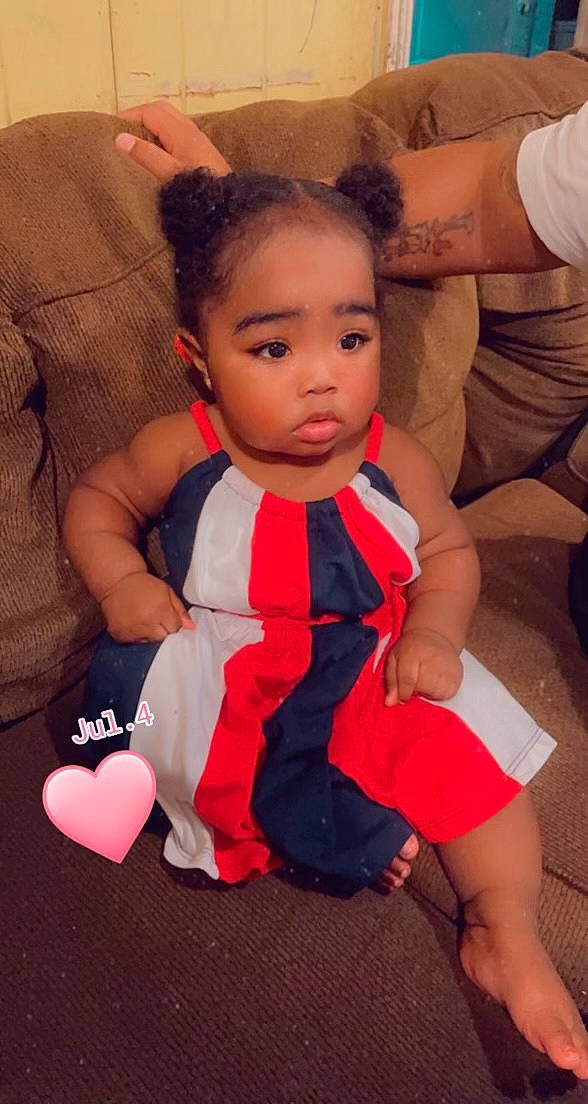 Paris is registered to the contest to win money with this photo: abdomen, baby, baby_toddler_clothing, chair, cheek, child, comfort, eye, finger, fun, happy, joint, neck, orange, person, skin, sleeve, thigh, thumb, toddler