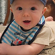 Asher joined the competition — help win amazing prizes! baby, infant, cap, blue_cap, bib, striped_bib, pirate_ship, carpet, floor, indoor, cute, drool, smiling, happy, child, person, portrait, young, casual_clothing, home
