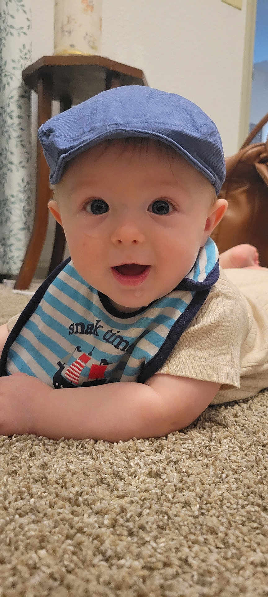 Asher joined the competition — help win amazing prizes! baby, infant, cap, blue_cap, bib, striped_bib, pirate_ship, carpet, floor, indoor, cute, drool, smiling, happy, child, person, portrait, young, casual_clothing, home