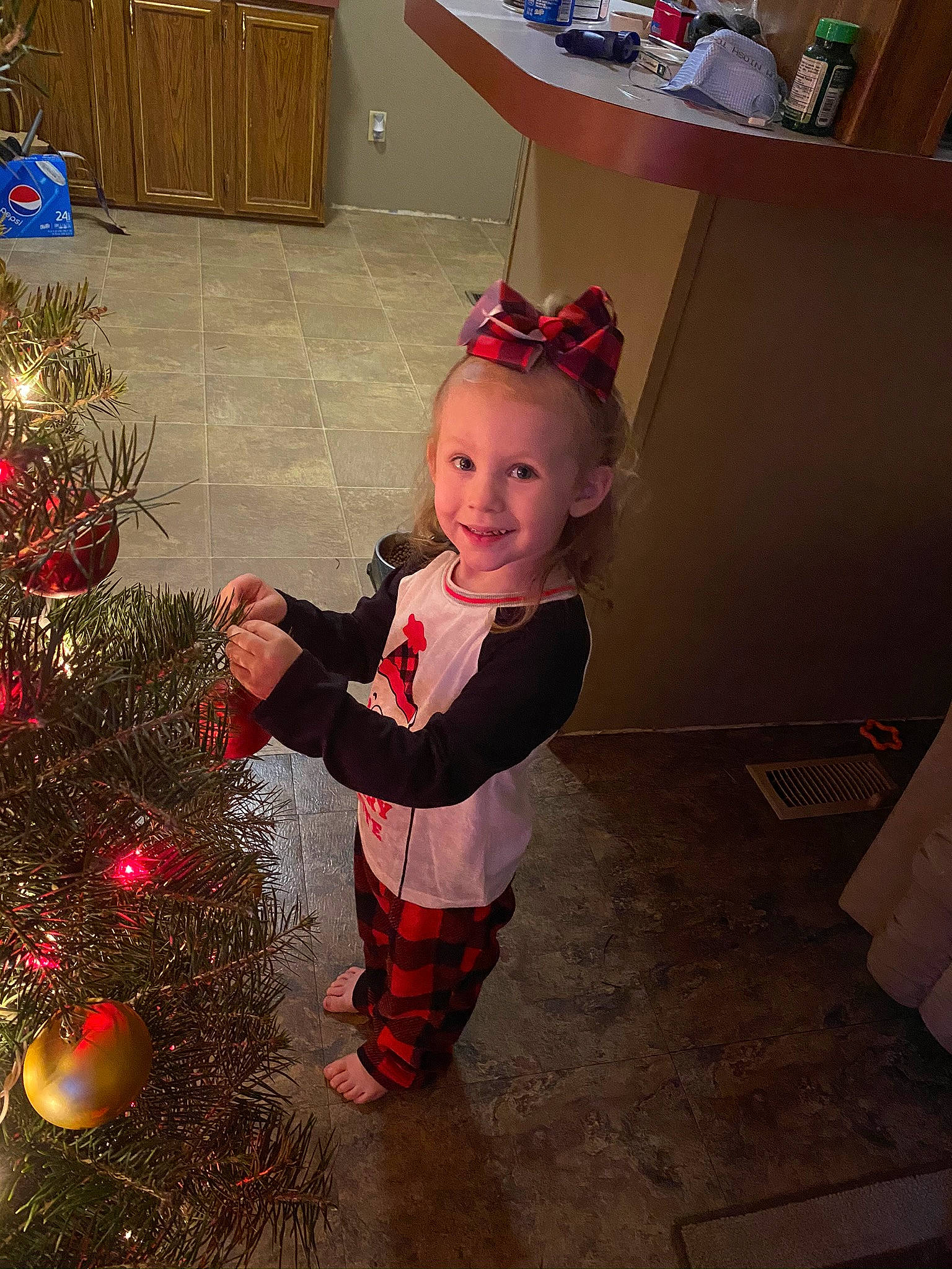 Jaycee is registered to the contest to win money with this photo: child, christmas, christmas_decoration, christmas_eve, christmas_ornament, christmas_tree, costume, event, fir, holiday, holiday_ornament, interior_design, person, smile, standing, toddler, tree