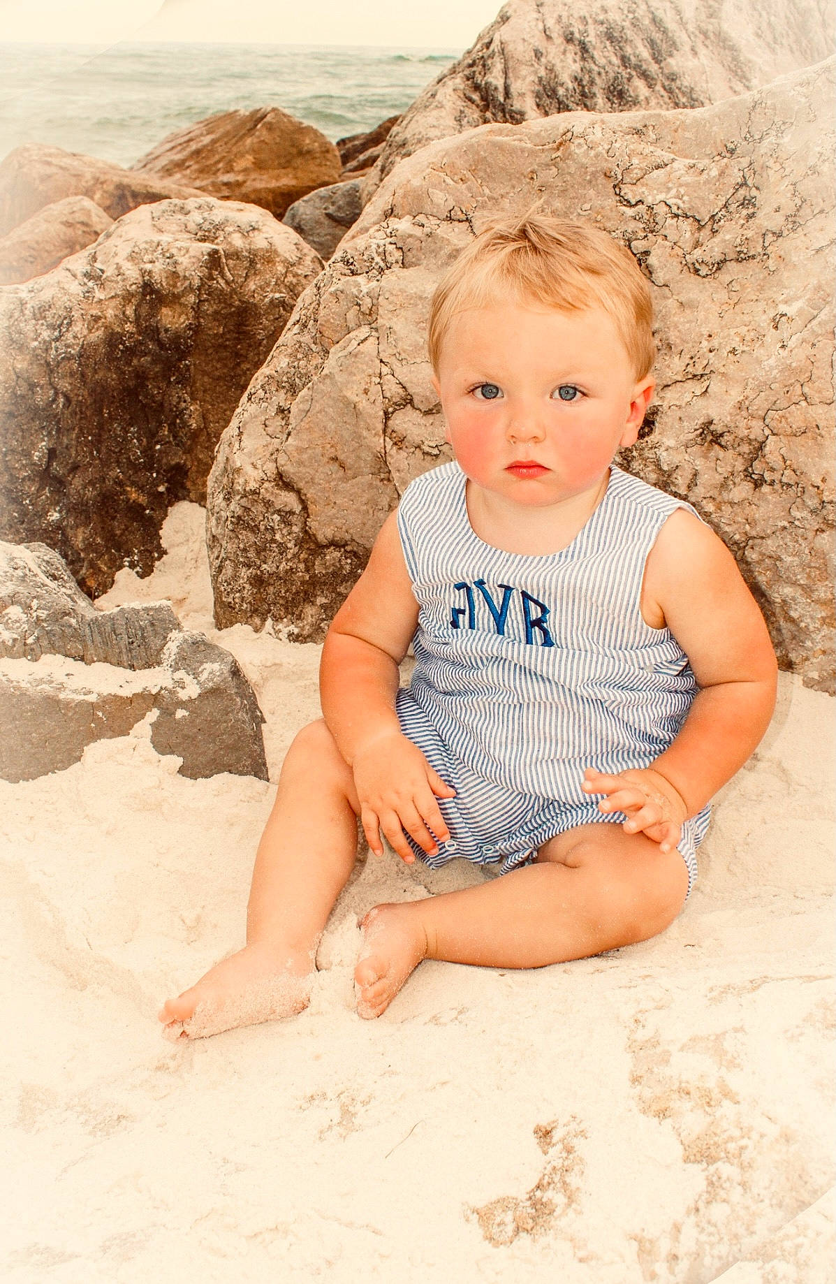 Blayne is registered to the contest to win money with this photo: baby, baby_toddler_clothing, barefoot, beach, child, dress, eye, face, fun, happy, human_body, leg, leisure, people_in_nature, person, recreation, sitting, skin, standing, t_shirt