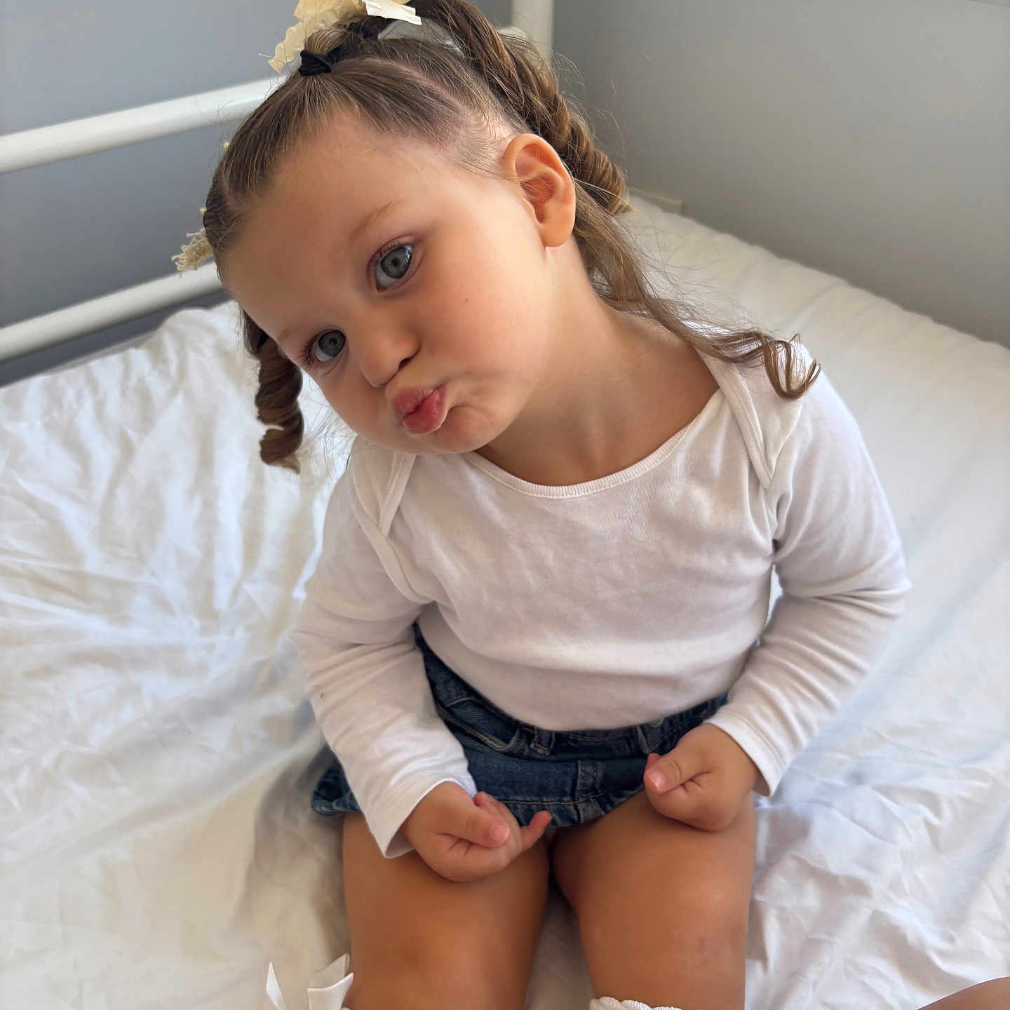 Amela is registered to the contest to win money with this photo: bed, bow, braided_hair, child, cute, denim_skirt, face, girl, indoor, knee_socks, natural_light, playful, portrait, posing, sitting, skin, white_bed_sheets, white_shirt, window, young