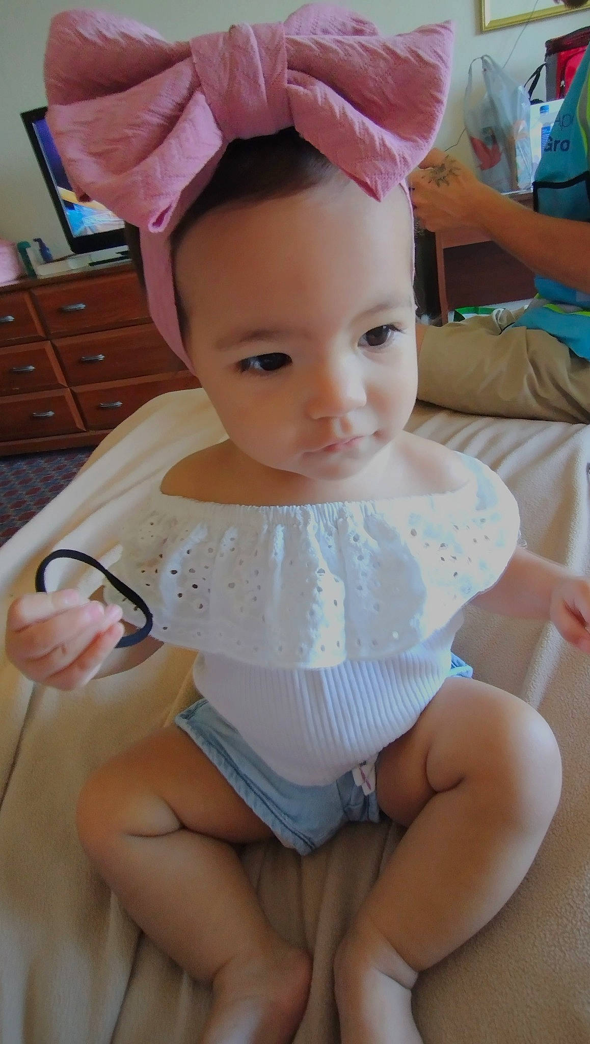 Cali is registered to the contest to win money with this photo: baby_toddler_clothing, cabinetry, cap, cheek, chest_of_drawers, chin, drawer, eye, eyelash, finger, happy, head, headgear, neck, person, pink, skin, sleeve, thigh, toddler