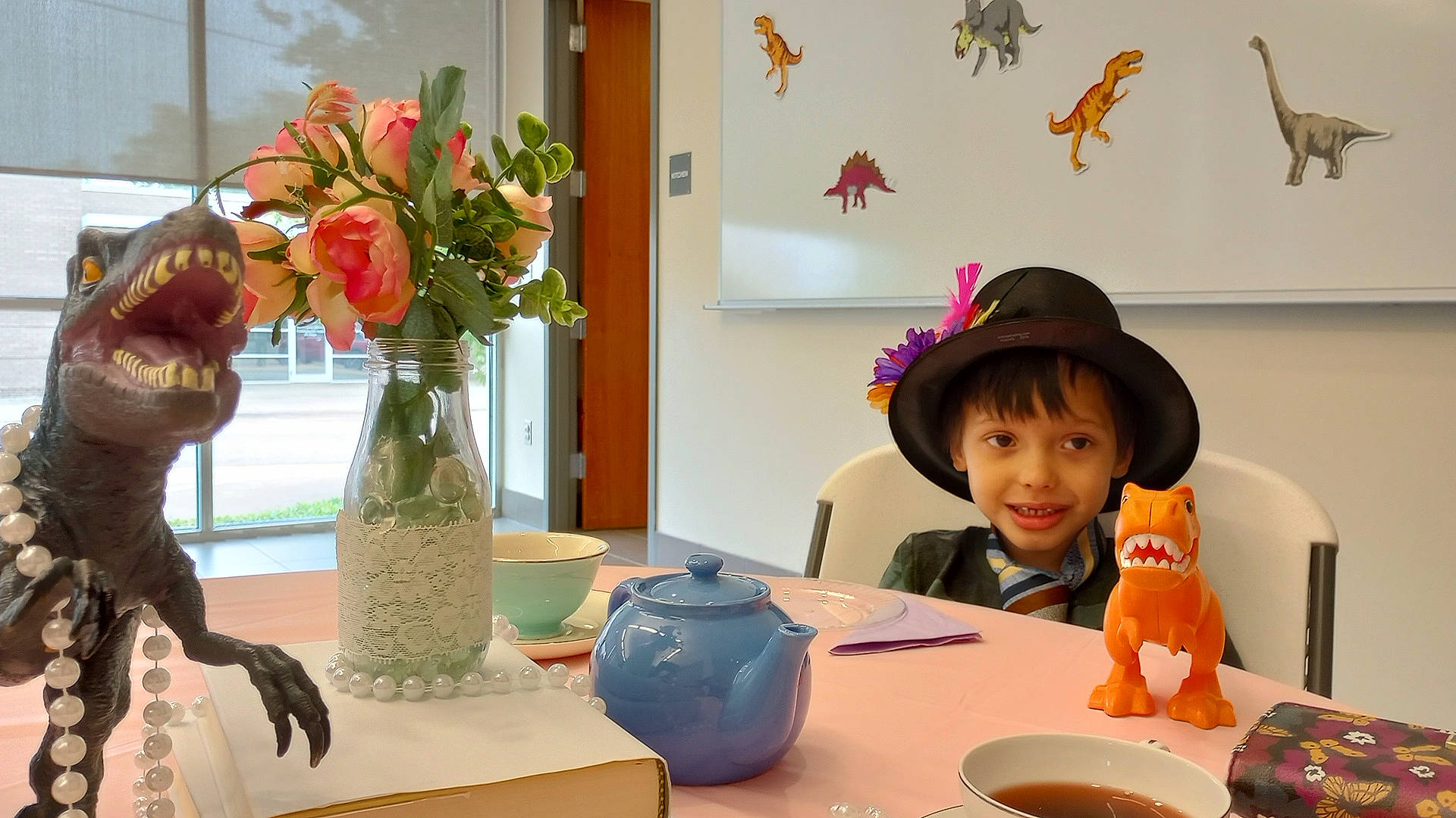 Riven is registered to the contest to win money with this photo: cup, event, fashion_accessory, flower, flower_arranging, flowerpot, hat, interior_design, joy, orange, person, plant, plate, room, smile, snapshot, sun_hat, table, tableware, toddler