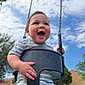 Leonidas joined the competition — help win amazing prizes! baby, child, swing, playground, outdoor, sky, clouds, grass, happy, smiling, striped_clothing, holding, fun, daytime, nature, greenery, face, person, infant, park