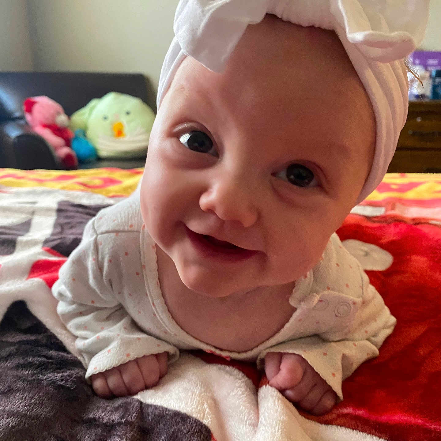 Amelia joined the competition — help win amazing prizes! baby, babylaughing, bed, bedroom, blanket, clothing, face, furniture, happy, hat, head, homedecor, indoors, person, photography, portrait, quilt, room, smile, towel