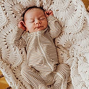 Enzo joined the competition — help win amazing prizes! baby, newborn, sleeping, striped_clothing, blanket, knitted, cradle, wood, infant, cozy, cute, peaceful, resting, portrait, child, soft, warm, indoors, person, one_piece