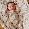 baby, newborn, sleeping, striped_clothing, blanket, knitted, cradle, wood, infant, cozy, cute, peaceful, resting, portrait, child, soft, warm, indoors, person, one_piece