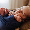 Enzo joined the competition — help win amazing prizes! baby, infant, swaddle, blue_clothing, cushion, brown, closeup, face, feet, toes, hand, lying_down, indoors, soft_light, portrait, newborn, cute, cozy, expression, resting