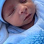 baby, newborn, infant, sleeping, portrait, close_up, blue_blanket, hat, swaddle, cozy, peaceful, soft_texture, face, closed_eyes, tiny_nose, lips, skin, laying_down, blanket, drool