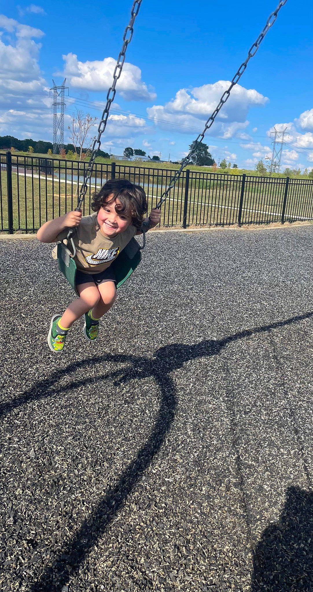 Chandler is registered to the contest to win money with this photo: asphalt, ball, city, cloud, exercise, grass, joy, knee, leg, leisure, line, people_in_nature, person, player, playground, road_surface, shorts, sky, soil, sports