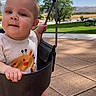 baby, child, infant, swing, playground, outdoor, park, smiling, portrait, face, person, sitting, standing, sunlight, blue_sky, mountains, trees, grass, pavement, playground_equipment