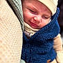 baby, child, sleeping, smiling, face, hat, clothing, warm, cozy, blue_vest, beige, blanket, soft, portrait, cute, infant, closeup, peaceful, resting, nap