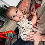 Elias joined the competition — help win amazing prizes! toddler, child, adult, person, outdoor, concrete, toy, play, shirt, insect_print, hand, holding, garden, plant, brick, floor, sitting, face, eyes, casual_clothing