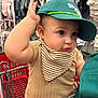 arm, baby, cap, cheeks, child, clothing, curious, cute, face, hat, indoor, infant, portrait, retail, seat, shopping, shopping_cart, store, striped_bib, young_child